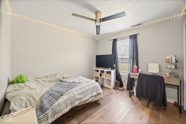 3914 Chenango Pl, West Lafayette, IN 47906 - bedroom featuring wood finished floors, a ceiling fan, a textured ceiling, and an office area