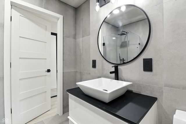 8138 Harrison Dr, Lawrence, IN 46226 - full bathroom with vanity, a shower stall, and tile walls