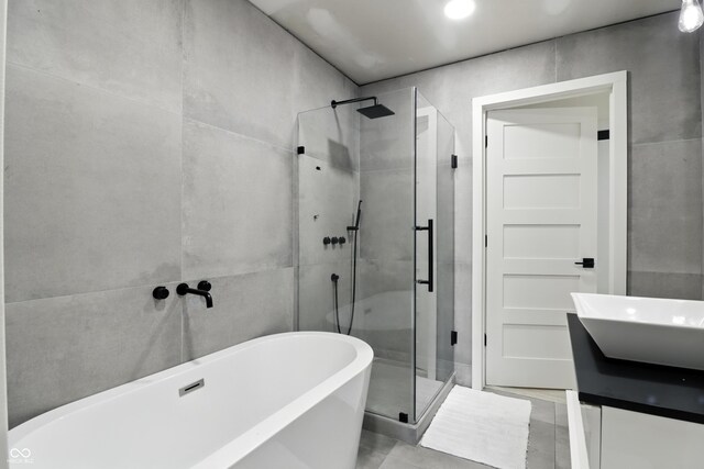 8138 Harrison Dr, Lawrence, IN 46226 - bathroom featuring a shower stall, a freestanding tub, and double vanity
