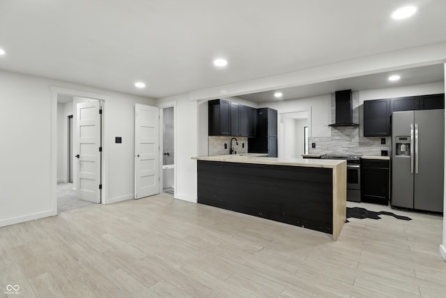 8138 Harrison Dr, Lawrence, IN 46226 - kitchen with appliances with stainless steel finishes, wall chimney range hood, light countertops, decorative backsplash, and recessed lighting