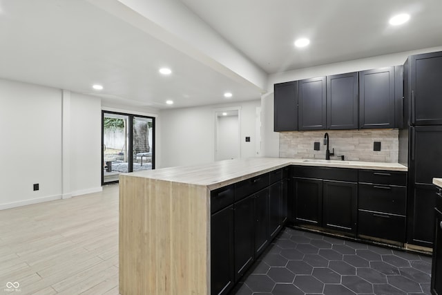 8138 Harrison Dr, Lawrence, IN 46226 - kitchen with a peninsula, recessed lighting, tasteful backsplash, and dark cabinets