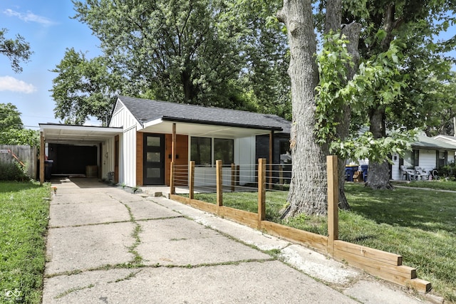 8138 Harrison Dr, Lawrence, IN 46226 - view of front facade featuring board and batten siding, concrete driveway, a porch, an attached garage, and roof with shingles