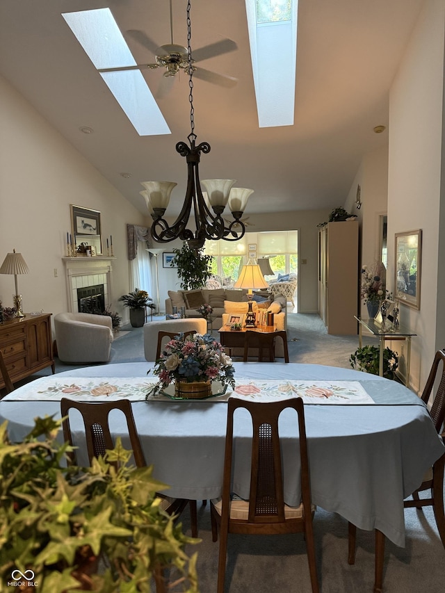 8048 River Bay Dr E, Indianapolis, IN 46240 - dining space with a skylight, light carpet, a chandelier, a fireplace, and high vaulted ceiling