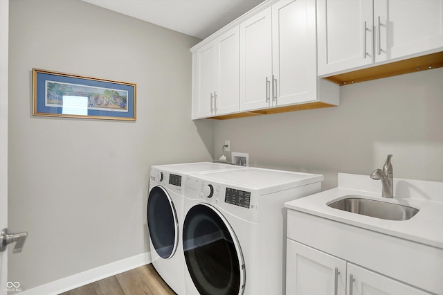 355 Ehrlich Ln, Westfield, IN 46074 - laundry room with separate washer and dryer, cabinet space, and light wood-type flooring