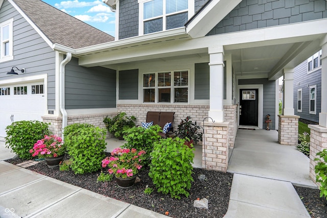 355 Ehrlich Ln, Westfield, IN 46074 - property entrance featuring a porch, a shingled roof, and brick siding