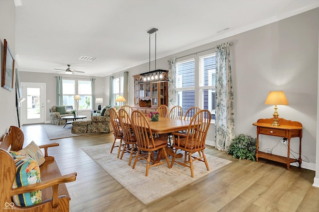355 Ehrlich Ln, Westfield, IN 46074 - dining space with light wood finished floors, a ceiling fan, and crown molding