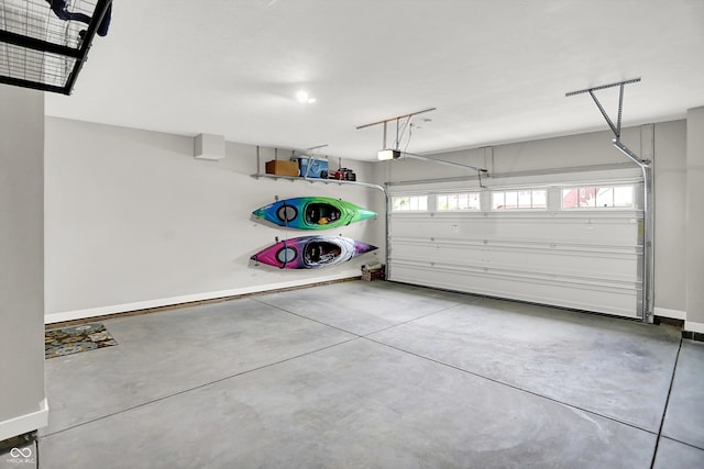 355 Ehrlich Ln, Westfield, IN 46074 - garage featuring baseboards and a garage door opener