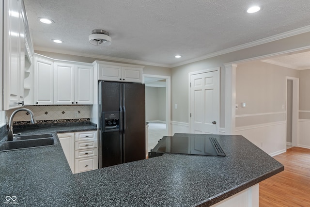 10184 Lakeshore Dr E, Carmel, IN 46033 - kitchen featuring black fridge with ice dispenser, dark countertops, light wood-style floors, tasteful backsplash, and white cabinetry