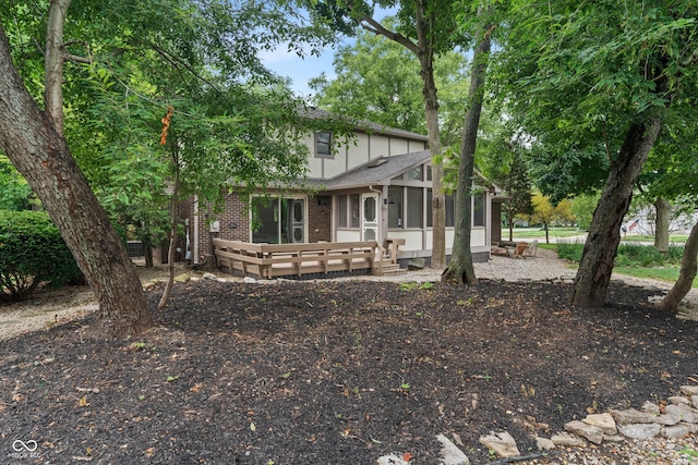 10184 Lakeshore Dr E, Carmel, IN 46033 - view of front of property with a sunroom, brick siding, and a wooden deck