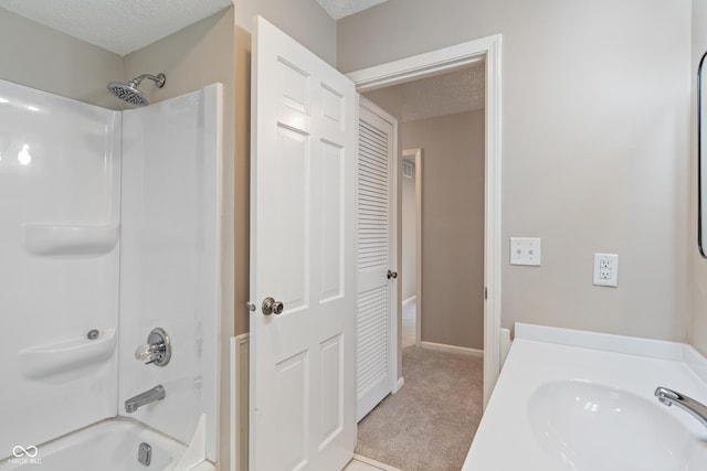 10184 Lakeshore Dr E, Carmel, IN 46033 - bathroom featuring shower / washtub combination, a textured ceiling, and vanity