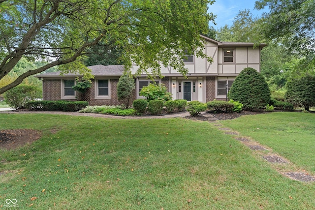 10184 Lakeshore Dr E, Carmel, IN 46033 - view of front of home featuring brick siding, a front lawn, and stucco siding
