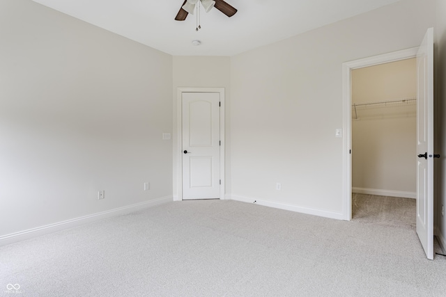 2570 Congress St, Carmel, IN 46032 - unfurnished bedroom with light colored carpet, a walk in closet, and ceiling fan