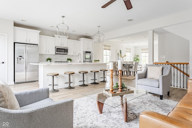 2570 Congress St, Carmel, IN 46032 - living room featuring light wood-type flooring, a ceiling fan, and recessed lighting