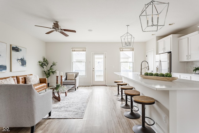 2570 Congress St, Carmel, IN 46032 - living room featuring light wood-style floors, a ceiling fan, and recessed lighting