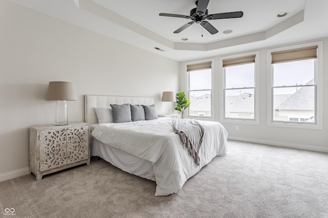 2570 Congress St, Carmel, IN 46032 - bedroom featuring a tray ceiling, light carpet, and a ceiling fan