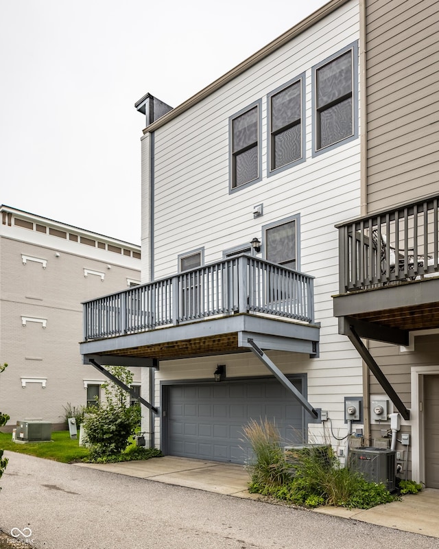 2570 Congress St, Carmel, IN 46032 - rear view of property featuring a balcony and a garage