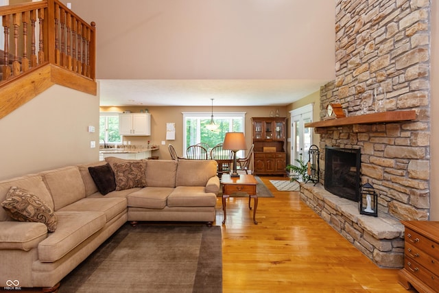 3750 S Whitehorse Rd, Nashville, IN 47448 - living room with light wood-style floors, a fireplace, and a towering ceiling