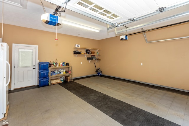 3750 S Whitehorse Rd, Nashville, IN 47448 - garage featuring a garage door opener and freestanding refrigerator