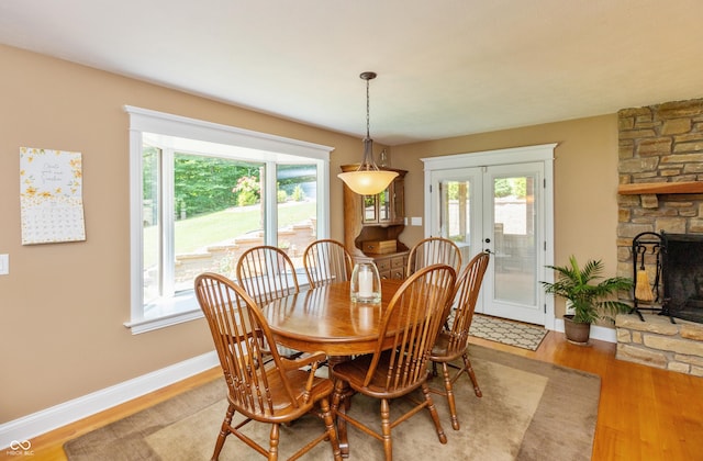 3750 S Whitehorse Rd, Nashville, IN 47448 - dining space featuring light wood-style flooring, healthy amount of natural light, a fireplace, and french doors