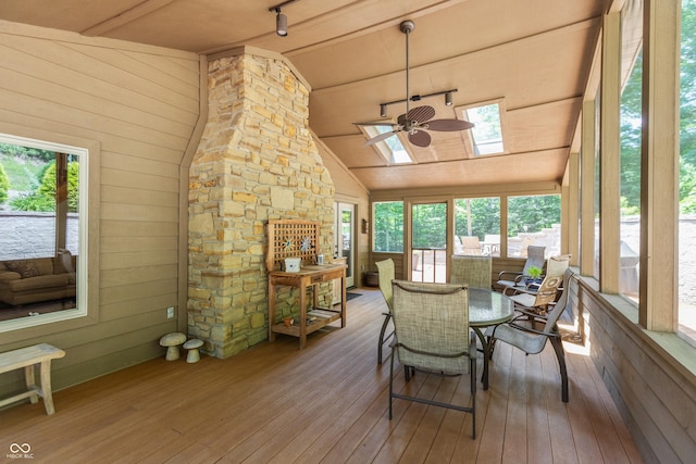 3750 S Whitehorse Rd, Nashville, IN 47448 - dining room with wood-type flooring, a skylight, vaulted ceiling, ceiling fan, and wood walls
