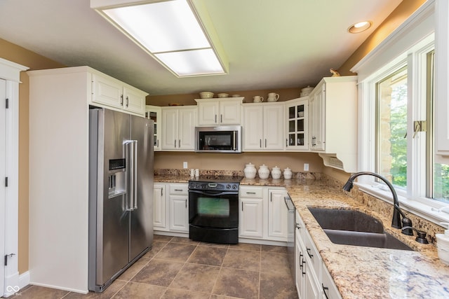 3750 S Whitehorse Rd, Nashville, IN 47448 - kitchen with appliances with stainless steel finishes, glass insert cabinets, light stone countertops, white cabinetry, and recessed lighting