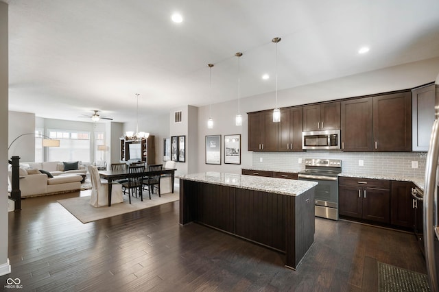 869 N Park Trail Dr, Carmel, IN 46032 - kitchen with appliances with stainless steel finishes, dark brown cabinets, backsplash, open floor plan, and recessed lighting
