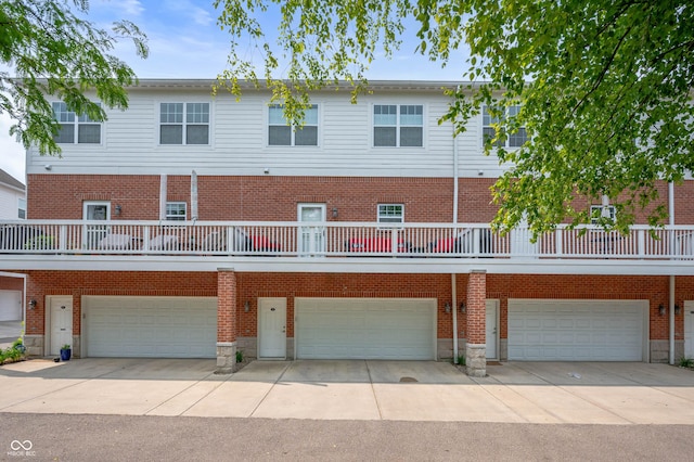 869 N Park Trail Dr, Carmel, IN 46032 - back of property with a garage, driveway, and brick siding