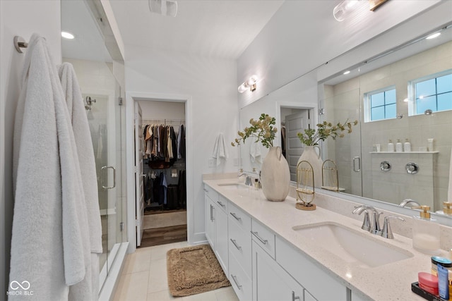 1275 Stonehaven Dr, Westfield, IN 46074 - full bathroom with double vanity, a shower stall, tile patterned flooring, and a walk in closet