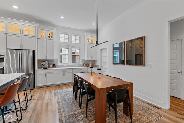 1275 Stonehaven Dr, Westfield, IN 46074 - dining space with ornamental molding, light wood-style floors, and recessed lighting