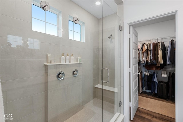 1275 Stonehaven Dr, Westfield, IN 46074 - bathroom featuring a stall shower, a walk in closet, and wood finished floors