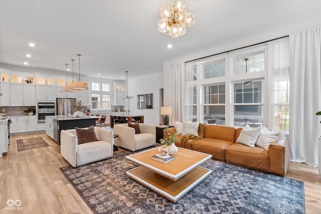 1275 Stonehaven Dr, Westfield, IN 46074 - living room featuring light wood-style flooring, recessed lighting, and a chandelier