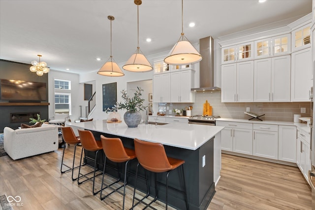 1275 Stonehaven Dr, Westfield, IN 46074 - kitchen with wall chimney exhaust hood, tasteful backsplash, light wood-style flooring, stove, and recessed lighting