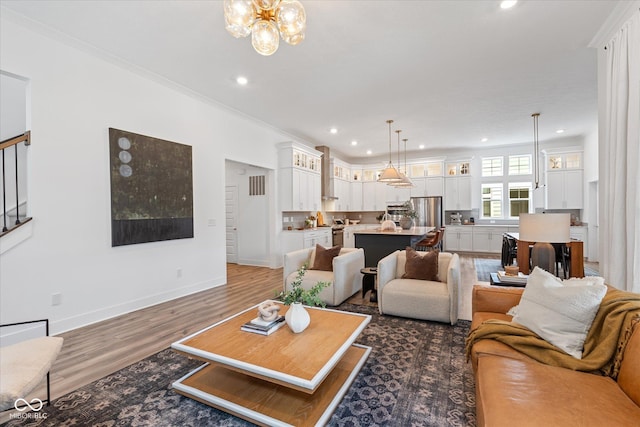 1275 Stonehaven Dr, Westfield, IN 46074 - living area with recessed lighting, wood finished floors, a chandelier, and ornamental molding