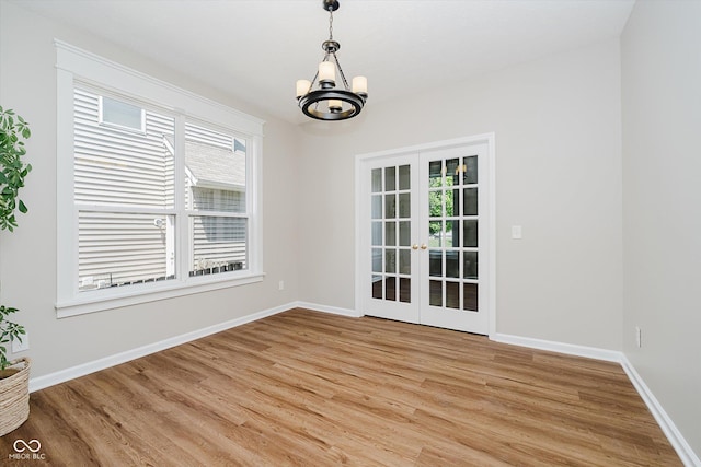 13722 Wendessa Dr, Fishers, IN 46038 - unfurnished dining area with light wood-style floors, a chandelier, and french doors