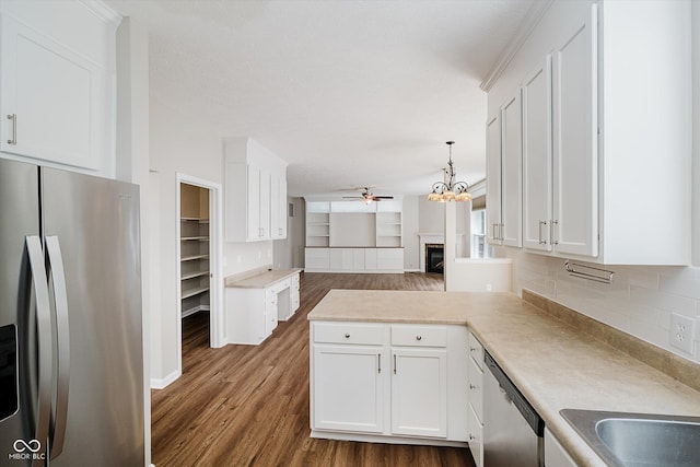 13722 Wendessa Dr, Fishers, IN 46038 - kitchen with appliances with stainless steel finishes, a ceiling fan, open floor plan, white cabinetry, and a peninsula