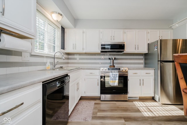 20 Druid Hill Ct, Carmel, IN 46032 - kitchen with stainless steel appliances, white cabinetry, light countertops, decorative backsplash, and light wood-type flooring