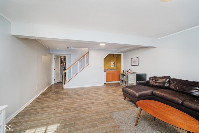 20 Druid Hill Ct, Carmel, IN 46032 - living room with stairs, light wood-style flooring, a dry bar, recessed lighting, and ornamental molding