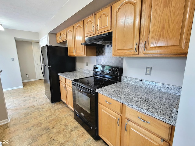 1047 S Jefferson St, Brownsburg, IN 46112 - kitchen with black appliances, under cabinet range hood, tasteful backsplash, and stone counters