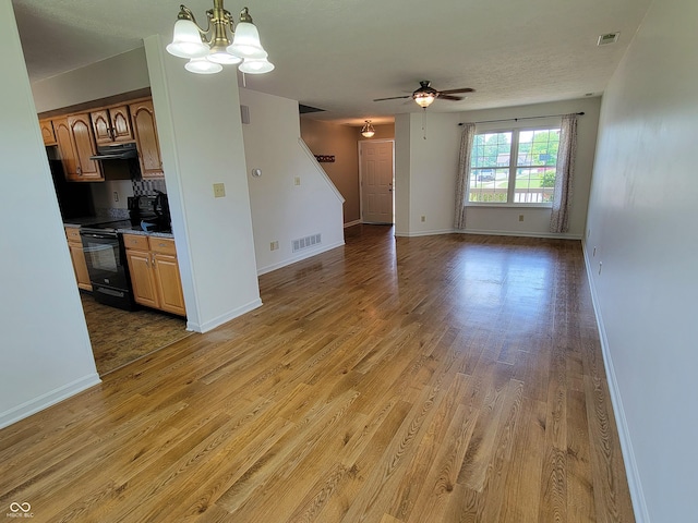 1047 S Jefferson St, Brownsburg, IN 46112 - unfurnished living room featuring ceiling fan, light wood finished floors, and a chandelier