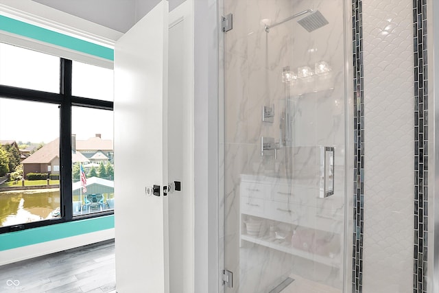 13417 Cambridge Cove Way, Fishers, IN 46055 - bathroom featuring plenty of natural light, a marble finish shower, and wood finished floors