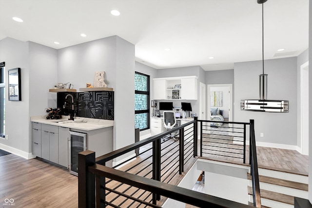 13417 Cambridge Cove Way, Fishers, IN 46055 - staircase with wine cooler, wood finished floors, recessed lighting, and wet bar