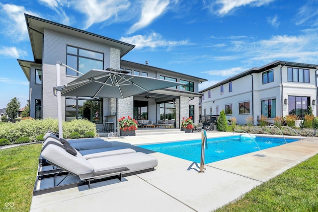 13417 Cambridge Cove Way, Fishers, IN 46055 - back of property featuring brick siding, a patio area, a ceiling fan, and an outdoor pool