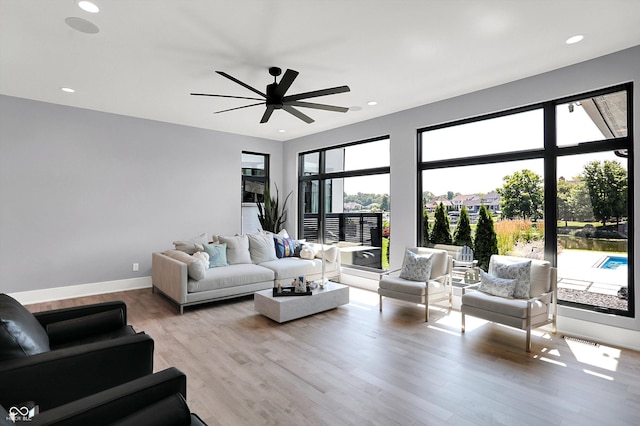 13417 Cambridge Cove Way, Fishers, IN 46055 - living area featuring light wood-type flooring, ceiling fan, and recessed lighting