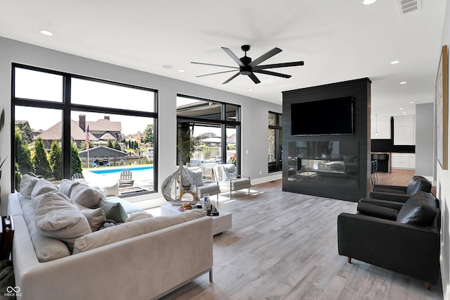 13417 Cambridge Cove Way, Fishers, IN 46055 - living area with ceiling fan, recessed lighting, and light wood-type flooring