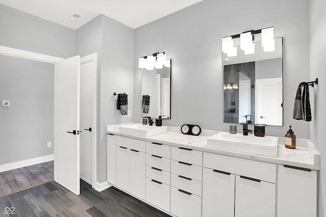 13417 Cambridge Cove Way, Fishers, IN 46055 - bathroom with double vanity, wood finished floors, and a shower
