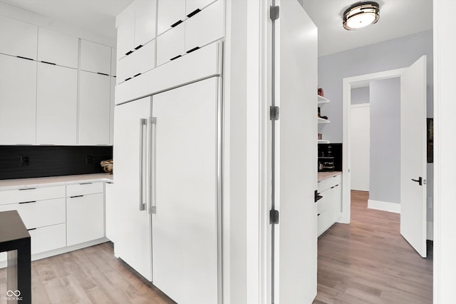 13417 Cambridge Cove Way, Fishers, IN 46055 - kitchen featuring paneled fridge, light wood-style flooring, white cabinets, and modern cabinets