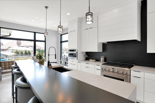 13417 Cambridge Cove Way, Fishers, IN 46055 - kitchen featuring appliances with stainless steel finishes, modern cabinets, tasteful backsplash, and recessed lighting
