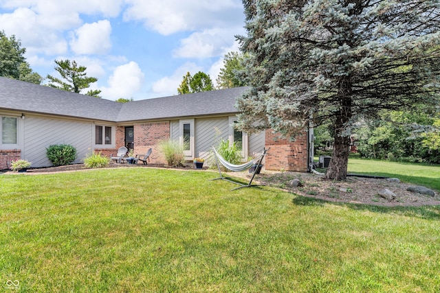 11534 Capistrano Cir, Indianapolis, IN 46236 - view of front of house with brick siding, a front lawn, and a shingled roof