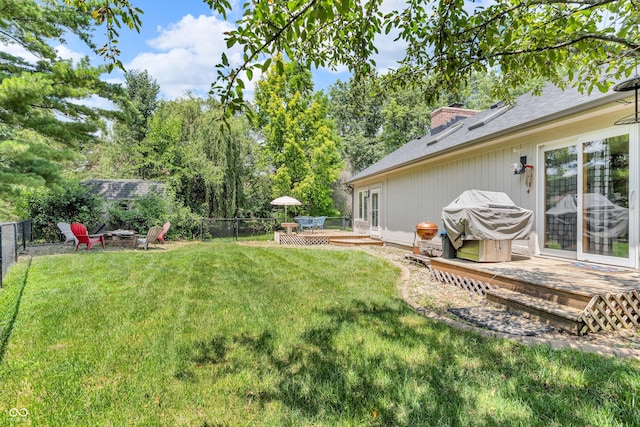 11534 Capistrano Cir, Indianapolis, IN 46236 - fenced backyard featuring a fire pit, a wooden deck, and view of wooded area