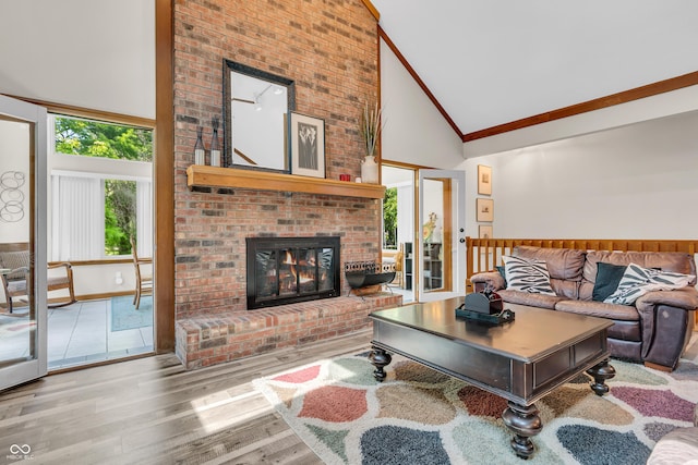 11534 Capistrano Cir, Indianapolis, IN 46236 - living room featuring high vaulted ceiling, healthy amount of natural light, crown molding, a brick fireplace, and wood finished floors